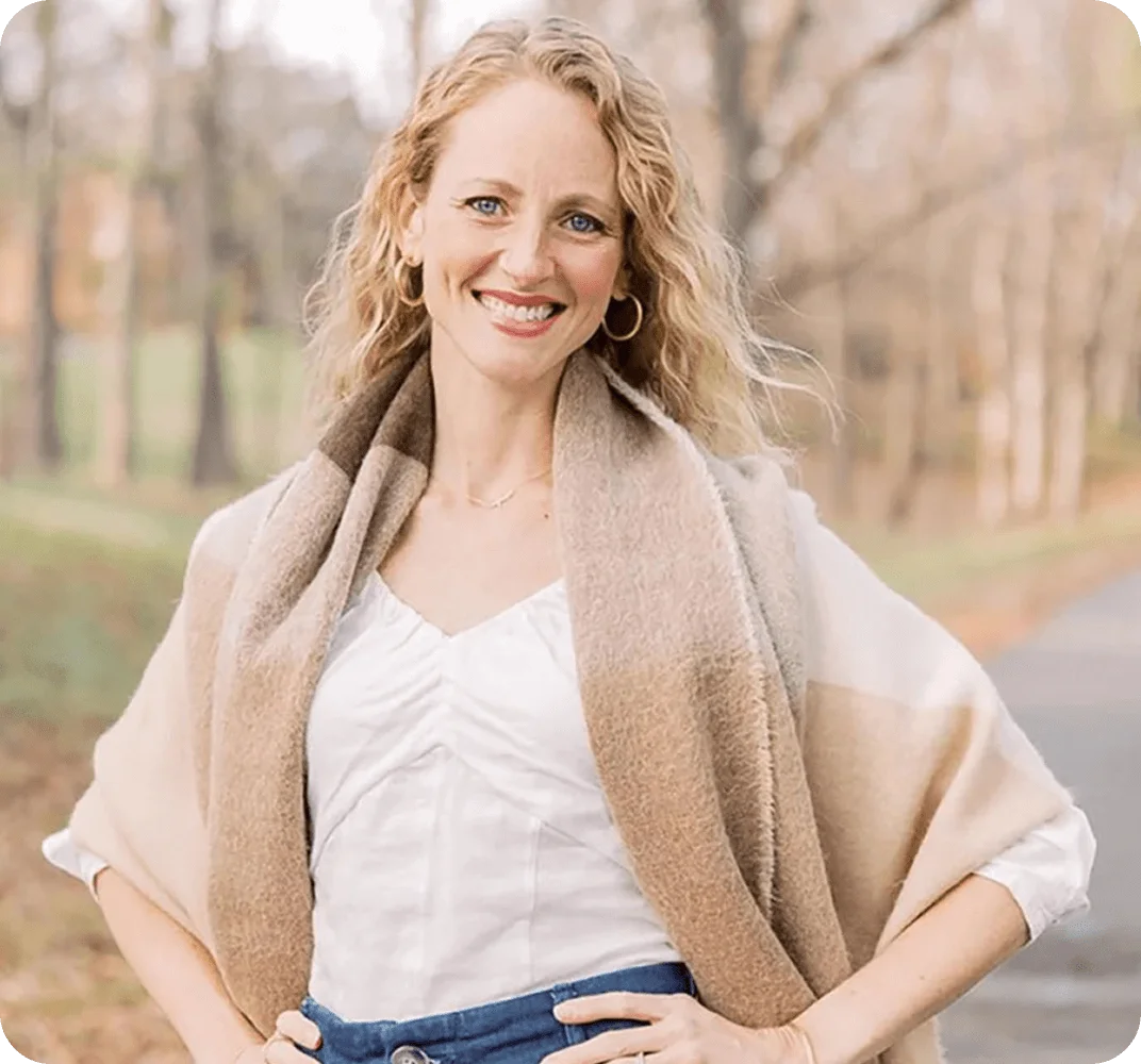 Outdoor portrait of a smiling woman standing on a wooded path in Kernersville, NC – Birch Stream Digital