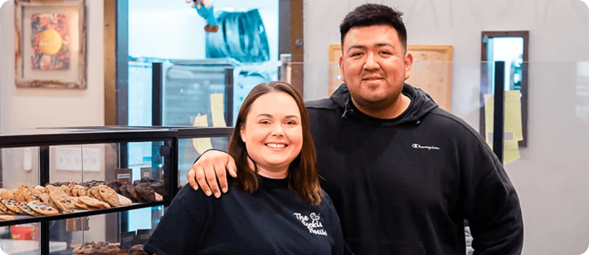 Small business owners smiling inside their bakery in Winston-Salem, NC – Birch Stream Digital